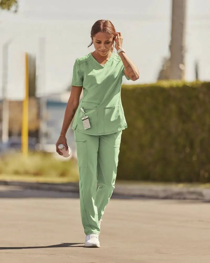female wearing custom light green scrub suit pair