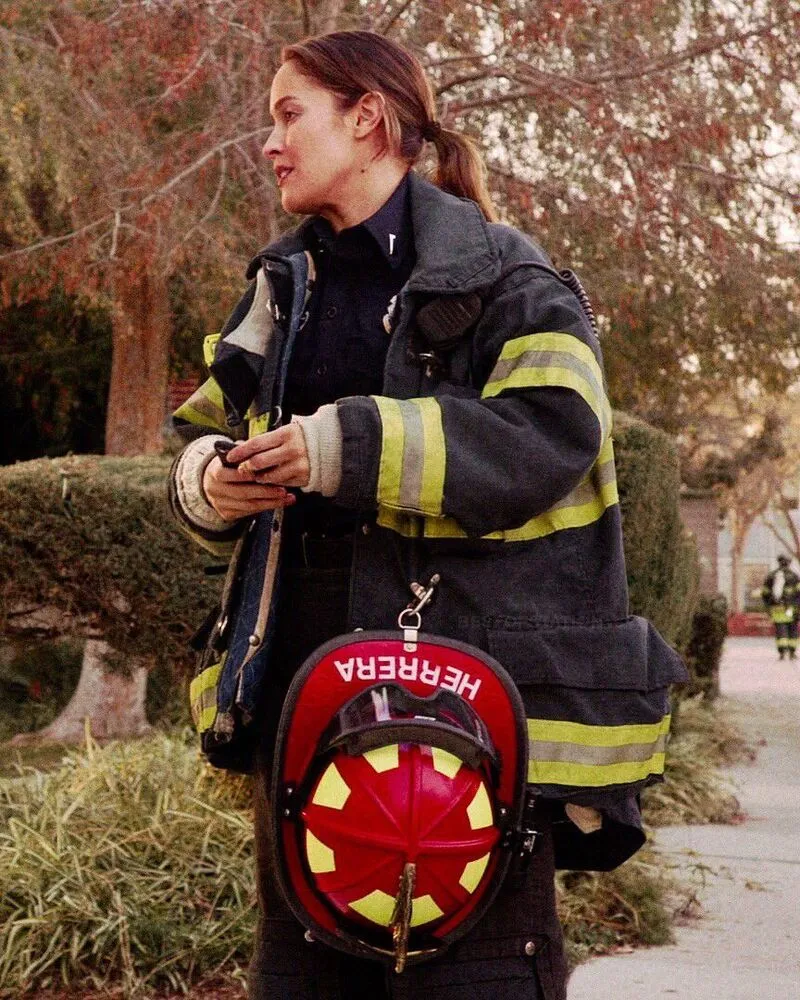 female wearing enhanced visibility quilted custom fire safety jacket standing in park