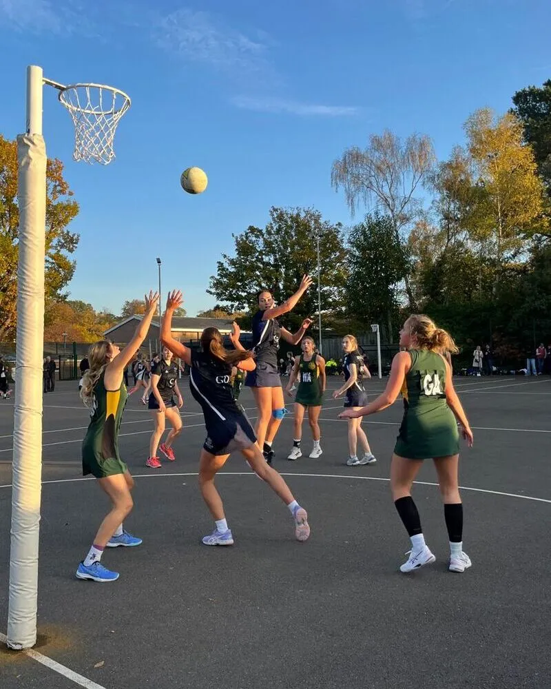 a group of women playing netball wearing custom uniforms