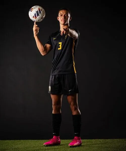 player wearing custom soccer uniform team number on front