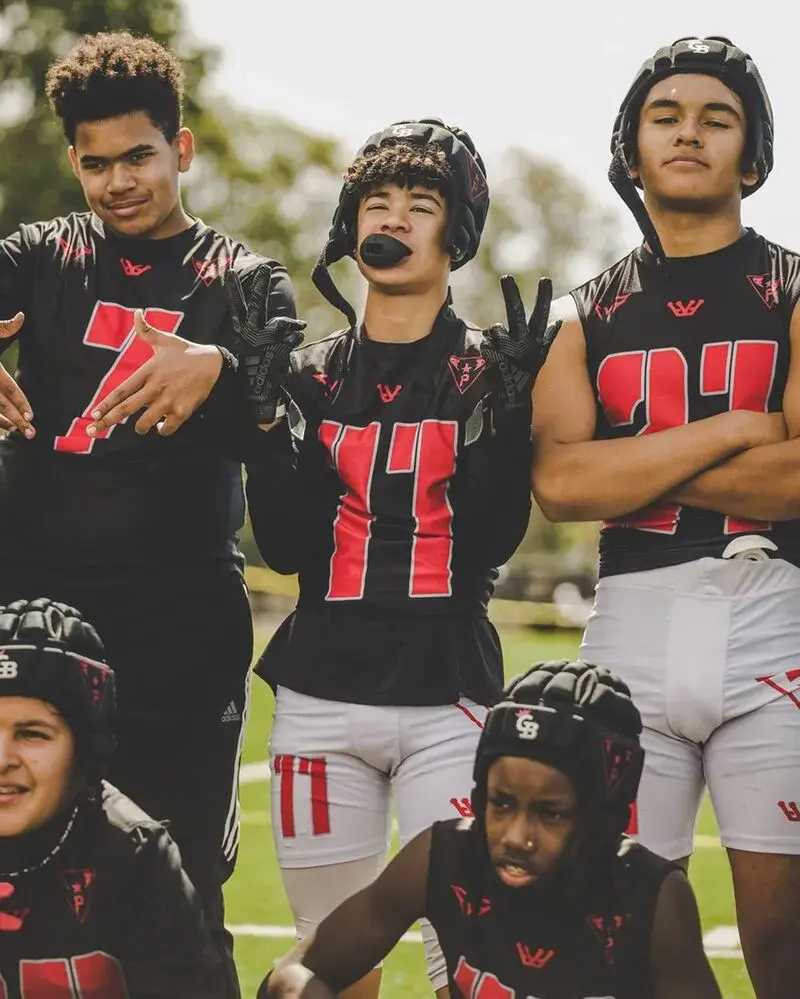 team players wearing custom 7v7 football uniform in black and white color posing for the photoshoot