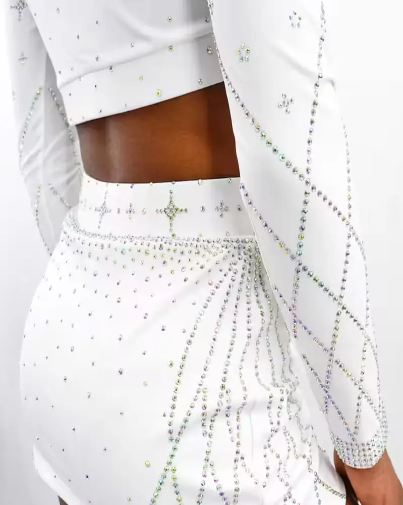female wearing custom white cheerleading dress rhinestone work on it
