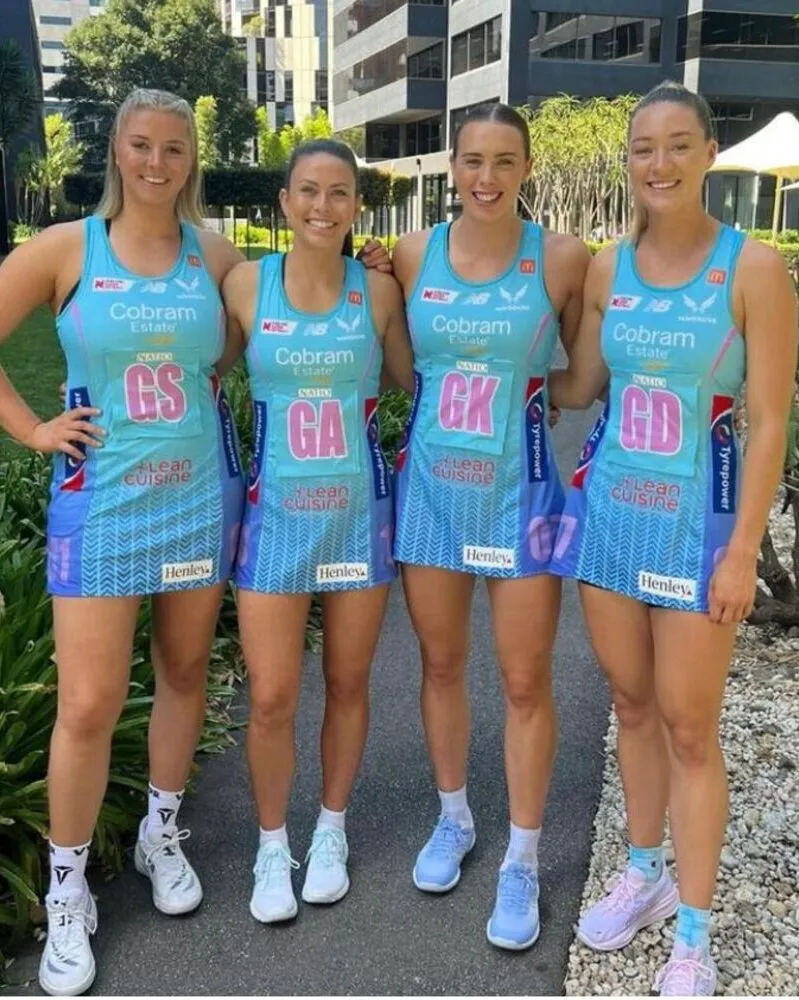 females wearing custom netball uniforms in sky blue color