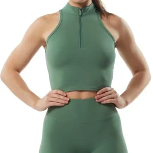 A woman wearing a sage green athletic set featuring a high-neck cropped top with a front quarter-zip and matching high-waisted leggings.