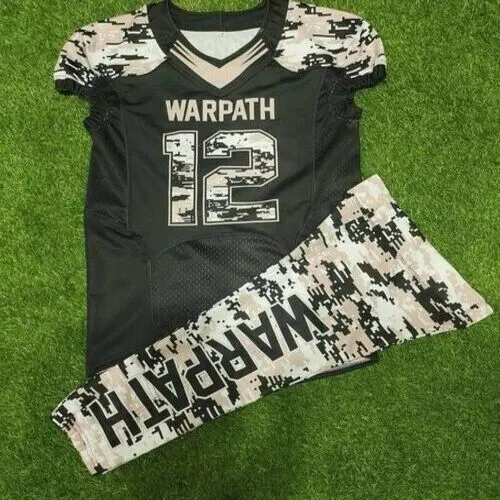 A custom American football uniform laid out on green grass, featuring a black jersey with the word warpath and number 12 in digital camouflage print, matching the patterned shoulders and athletic pants.