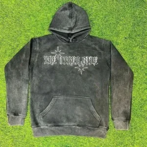 A charcoal grey acid-wash custom hoodie featuring a vintage distressed texture and a white celestial star graphic with gothic typography on the chest.