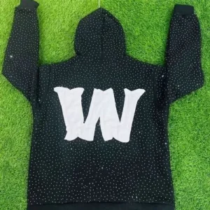 A close-up of a black custom hoodie featuring a large "W" initial crafted from silver rhinestones, perfect for luxury private label collections.