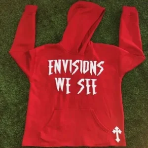 A bright red heavyweight hoodie featuring the text "ENVISIONS WE SEE" in a clean white puff print finish with a small cross detail near the hem.